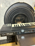 Keyboard in front of a fireplace with a stone wall background