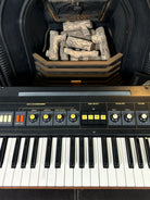 Keyboard instrument with a fireplace.