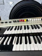Yamaha keyboard with close-up of keys and control panel.