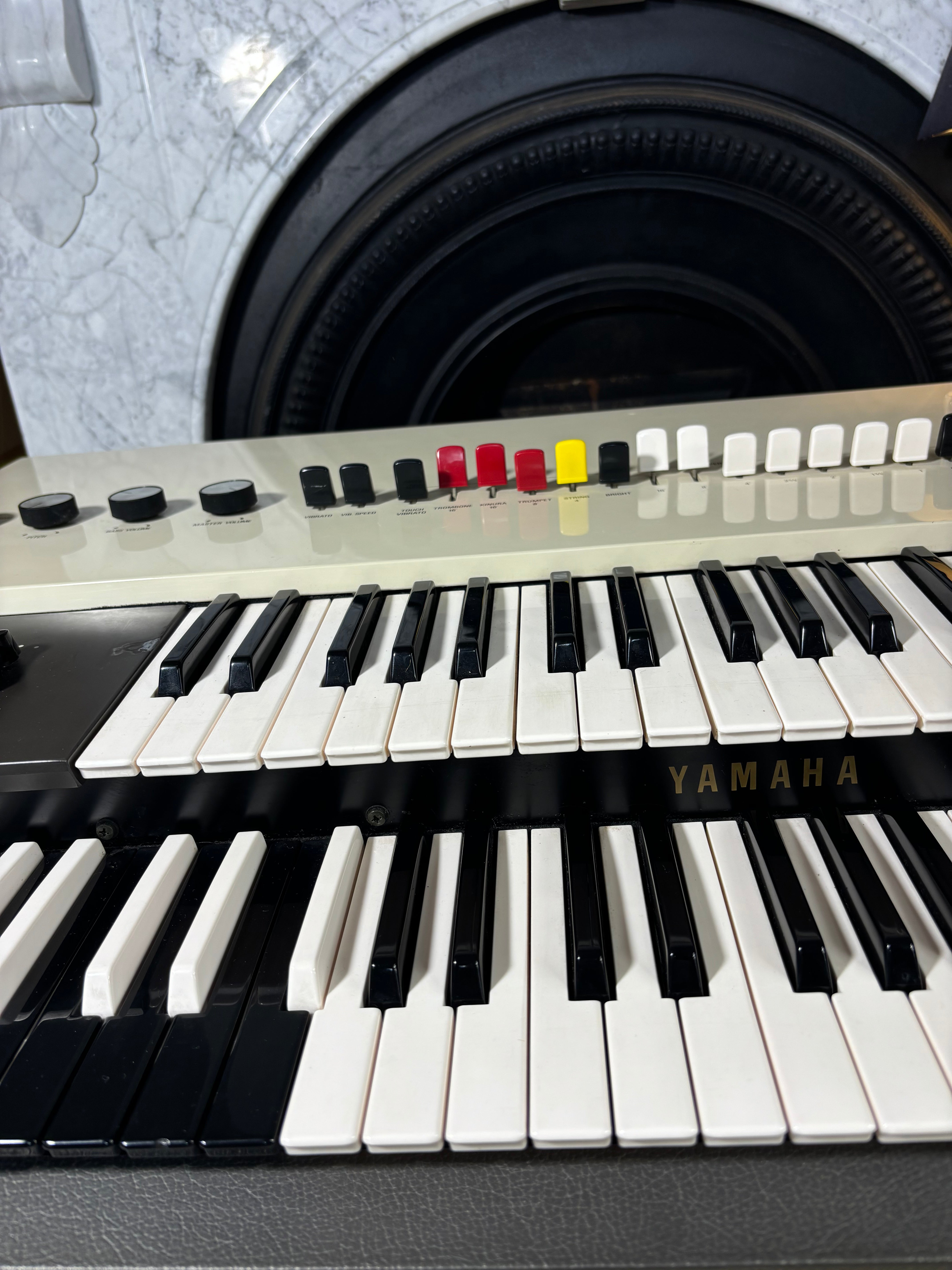 Yamaha keyboard with close-up of keys and control panel.